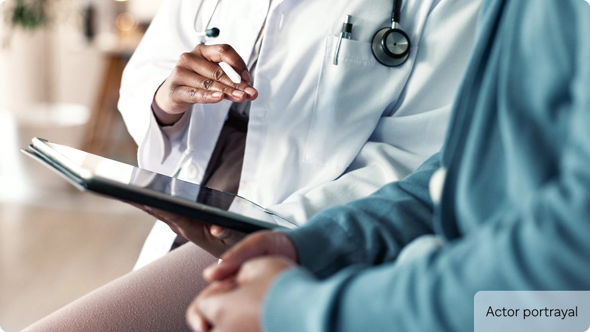 Doctor with tablet and patient