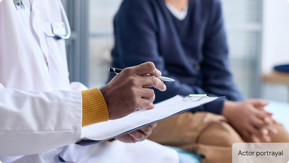 HCP with clipboard and patient