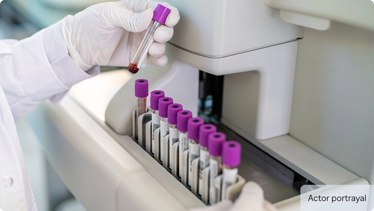 Actor portrayal of laboratory technician with test tubes