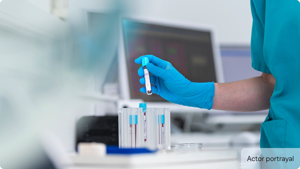 Actor portrayal of laboratory technician holding a test tube